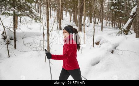 Winter sport. Cross Country skiing Classic Style Nordic Skiing in Forest. Woman in winter doing fun winter sport activity in the snow on cross country Stock Photo