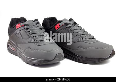 Gray warmed sneakers for sports, sports shoes isolated on white background Stock Photo