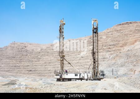 Blasthole drill in an open pit copper mine operation in Chile Stock Photo