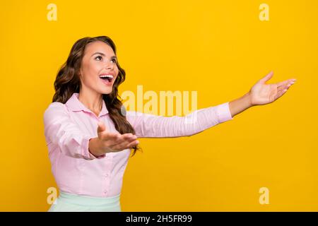 Photo of hooray millennial brunette lady hug empty space wear pink shirt isolated on yellow color background Stock Photo