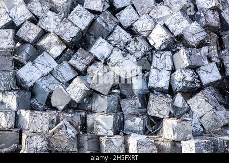 Scrap metal compressed into cubes, recycling yard Stock Photo