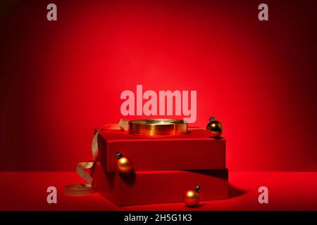 Empty red podium made of gift boxes and golden circle and decor on a red background. Pedestal, showcase for products and cosmetics. Chinese New Year c Stock Photo