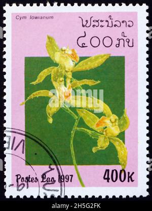 LAOS - CIRCA 1997: a stamp printed in Laos shows Lows cymbidium, cymbidium lowianum, is a species of evergreen flowering plants in the orchid family, Stock Photo