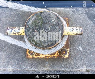 Stockholm, Sweden - April 17, 2021: A view from above on mooring rope around iron bollard Stock Photo