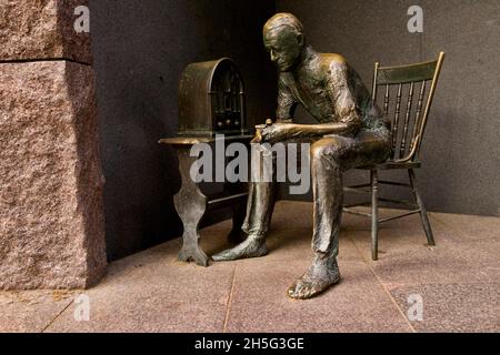Sculpture of man listening to a broadcast on vintage radio at the FDR Memorial in Washington DC on the National Mall Stock Photo