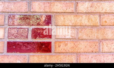 Stockholm, Sweden - April 15, 2021: Orange brick-wall with pattern of red glazed bricks Stock Photo