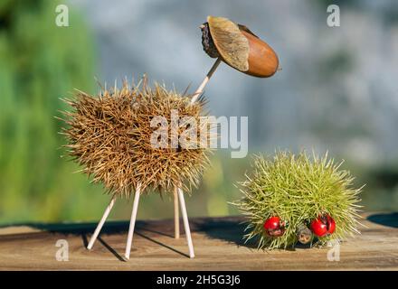 Sheep and hedgehook, funny animal figures made from chestnut shells and oak acorns in autumn time, Switzerland Stock Photo