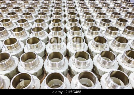 many metal pipe couplings in a pipe factory Stock Photo