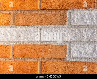 Stockholm, Sweden - April 15, 2021: Background with orange bricks in combination with white colored bricks Stock Photo