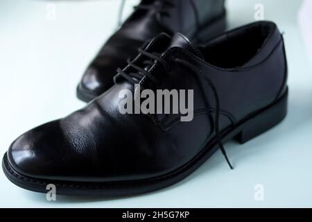 Close up of some fancy black bright shoes on a green surface Stock Photo