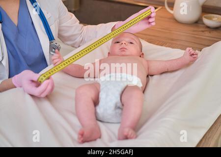 Newborn Medical Exam - Doctor Checking Head Size with a