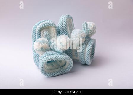 homemade knitted shoes for newborn boys on white background Stock Photo