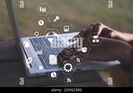 Multitasking on a laptop outdoors. Work from home or from a distance. Business innovation processes and tasks being completed simultaneously. Digital marketing sales strategy and planning infographic Stock Photo