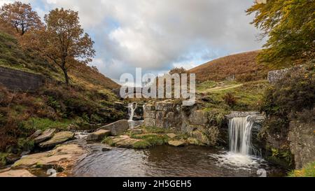 Two waterfalls captured in the pretty autumnal colours at Three Shires Head where the counties of Staffordshire, Cheshire and Derbyshire meet. Stock Photo