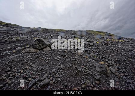 Laufskalar Cairn (Laufskalavaroa), Myrdalssandur Plain, Iceland.Moss-covered lava field Laufskálavarða, at back volcano Katla, Kirkjubæjarklaustur, Su Stock Photo