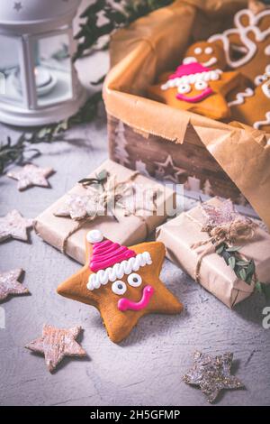 Gingerbread cookies for Christmas in cookie box with stars and small presents Stock Photo