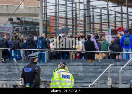 CARDIFF, WALES - NOVEMBER 09 2021: South Wales Police officers and PCSOs observe a demonstration against the increased use of vaccine passports Stock Photo