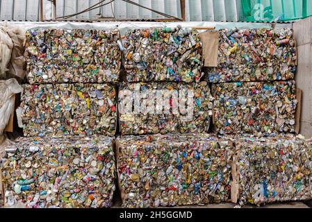 Pressed aluminum cans. Large bales of aluminum waste are waiting to be sent for remelting. Stock Photo