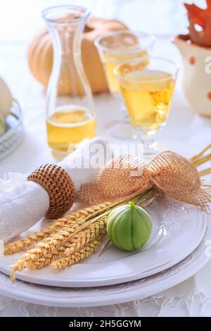 Place settings for Thanksgiving with pumpkins, ears and apple wine Stock Photo