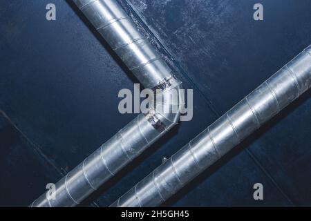 Ventilation pipe system at the ceiling of an industrial enterprise or plant premises. Stock Photo