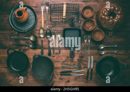 Assortment of vintage kitchen utensils on wooden table Stock Photo