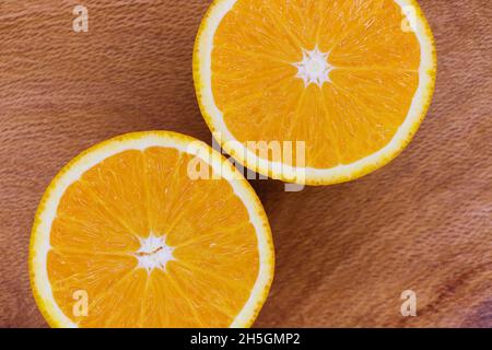 Valencia Orange Fruit Slices Abstract Layout On Wood (Citrus x sinensis) Stock Photo