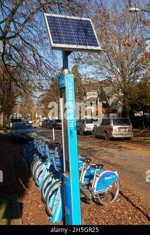 Mobi by Shaw Go bike sharing stand with solar panel on a residential street in Vancouver, British Columbia Canada Stock Photo