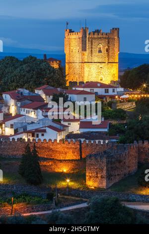 Bragança, Portugal - June 26, 2021: Keep of Bragança Castle in Portugal at dusk with houses from the medieval citadel and walls in the foreground. Stock Photo