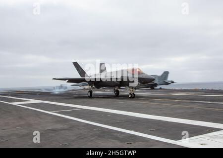 PACIFIC OCEAN (Nov. 7, 2021) An F-35C Lightning II, assigned to Marine Wing Fighter Attack Squadron (VMFA) 314, lands on the flight deck of the aircraft carrier USS Abraham Lincoln (CVN 72).  Abraham Lincoln is underway conducting routine operations in the U.S. 3rd Fleet. (U.S. Marine Corps photo by 1stLt. Charles Allen/Released) Stock Photo