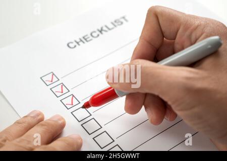 Hand with red marker pen marking on checklist box Stock Photo
