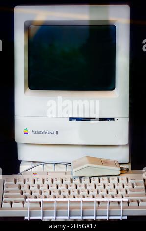 An Apple Macintosh Classic II computer is pictured in a shop window, Nov. 6, 2021, in Mobile, Alabama. The Macintosh Classic II was sold 1991-1993. Stock Photo