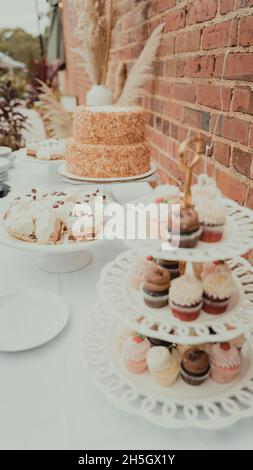 cupcakes arranged on a white metal three tier display Stock Photo