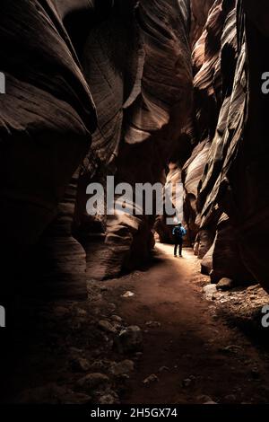 A Shaft of Sunlight Illuminates Hiker In Slot Canyon of Buckskin Gulch Stock Photo