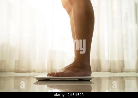 Female Bare Feet Standing On A Digital Scales. Weight Loss Stock Photo,  Picture and Royalty Free Image. Image 84250838.