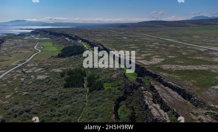 Aerial view of colliding tectonic plates at Thingvellir in Iceland. Drone view of plates connecting forming a longvalley, on a summer day. Stock Photo