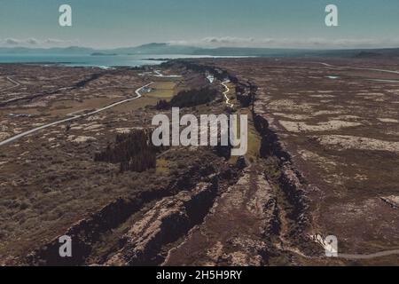 Aerial view of colliding tectonic plates at Thingvellir in Iceland. Drone view of plates connecting forming a longvalley, on a summer day. Stock Photo