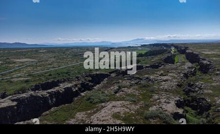 Aerial view of colliding tectonic plates at Thingvellir in Iceland. Drone view of plates connecting forming a longvalley, on a summer day. Stock Photo