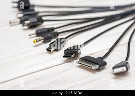 A large number of different connectors for connecting various gadgets via USB port to a laptop or computer. The concept of multitasking Stock Photo