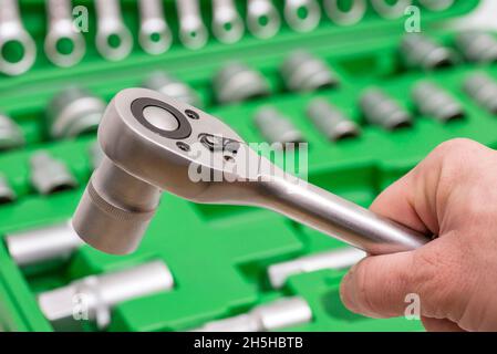 A set of tools for repair in car service - mechanic's hands, close up. Auto mechanic with working tools for repair and diagnostics of cars in the gara Stock Photo