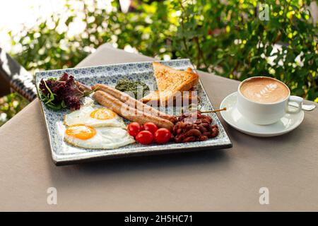 Served english breakfast with cappuccino coffee Stock Photo