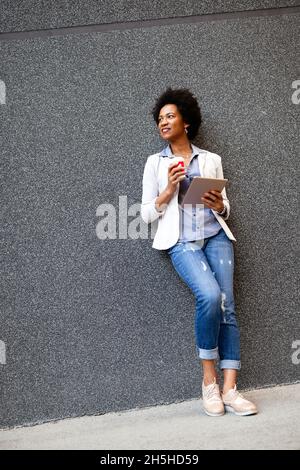 Business woman using tablet on coffee break in city Stock Photo