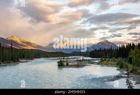 View of a valley with river, mountains in the evening light, Mount Hardisty and Mount Kerkeslin, sunset, Icefields Parkway, Athabasca River, Jasper Stock Photo
