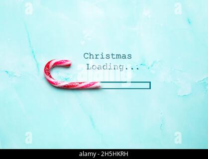 Merry Christmas concept, Christmas loading bar with candy cane top view on light blue background, Holiday, Christmas concept modern design waiting for Stock Photo