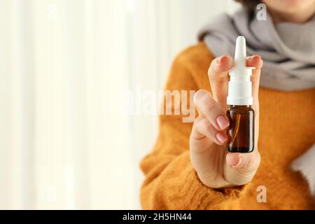 Woman holds nasal spray, space for text Stock Photo