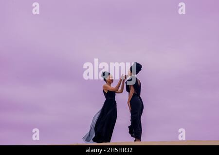 Woman standing on sand dune  Stock Photo