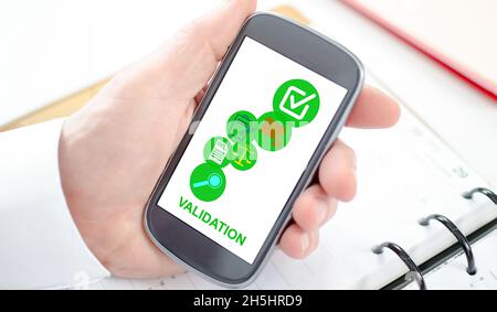 Validation concept shown on a smartphone screen Stock Photo