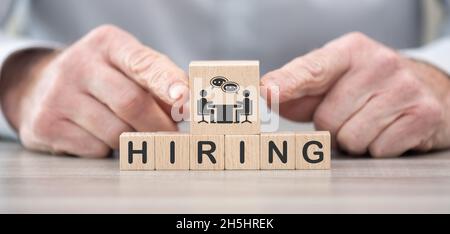 Wooden blocks with symbol of hiring concept Stock Photo