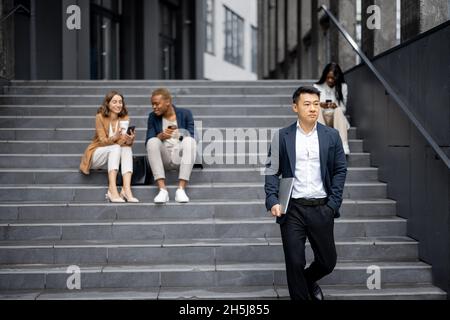 Business team talking and using digital devices Stock Photo