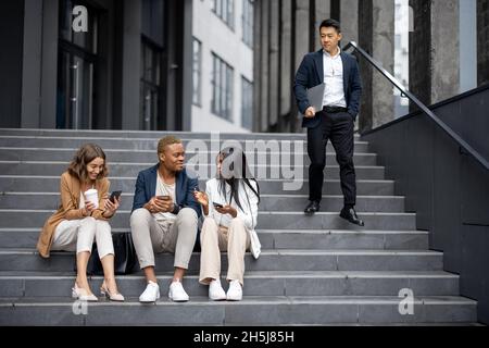 Business team talking and using digital devices Stock Photo