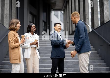 Multiracial business team bumping fists each other Stock Photo